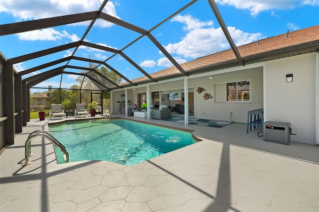 view of pool featuring glass enclosure and a patio area