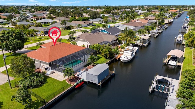 drone / aerial view with a water view and a residential view