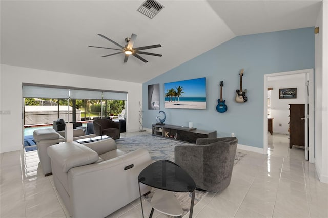 living area featuring light tile patterned floors, visible vents, baseboards, vaulted ceiling, and a ceiling fan