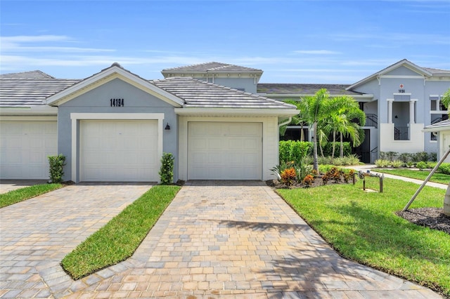 view of front facade featuring a garage and a front lawn