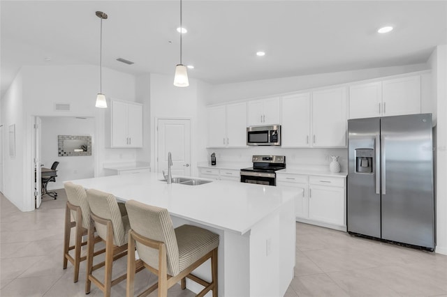 kitchen with stainless steel appliances, vaulted ceiling, white cabinetry, and sink