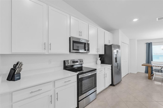 kitchen with white cabinetry, appliances with stainless steel finishes, and light tile patterned floors