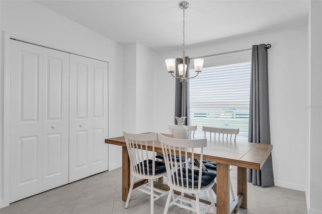 tiled dining area featuring a notable chandelier