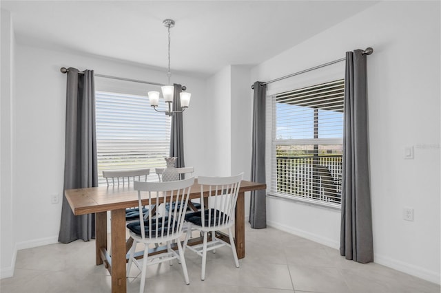 dining space with a notable chandelier, light tile patterned floors, and a wealth of natural light