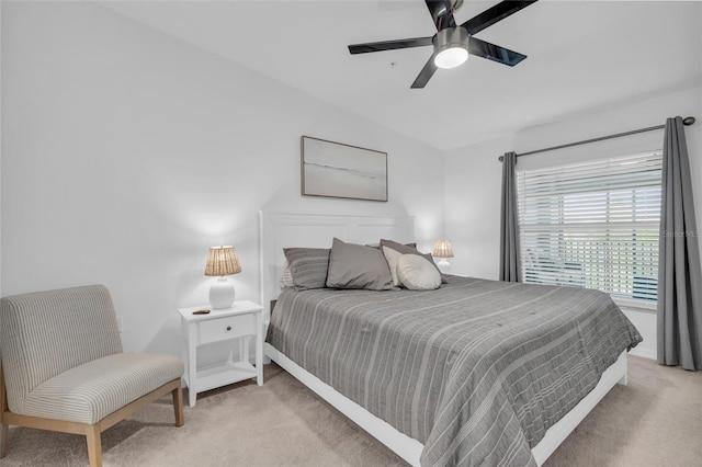 carpeted bedroom featuring ceiling fan and vaulted ceiling