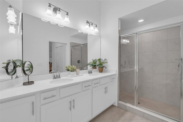 bathroom featuring tile patterned floors, an enclosed shower, and vanity