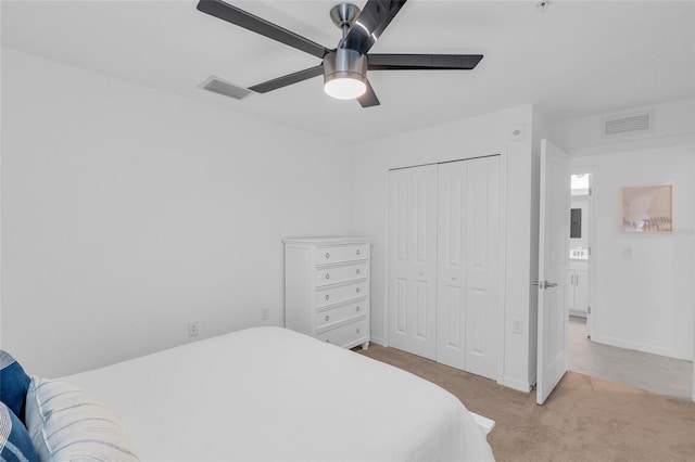 carpeted bedroom featuring a closet and ceiling fan