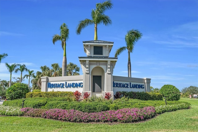 community / neighborhood sign with a lawn