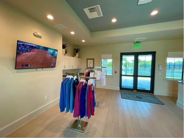 interior space with light hardwood / wood-style flooring and french doors