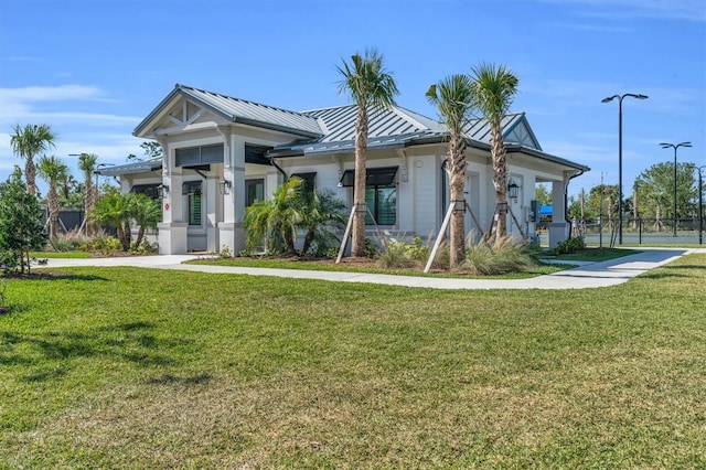 exterior space featuring covered porch and a front yard