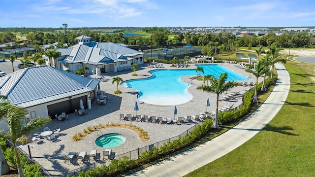 view of pool featuring a yard, a community hot tub, and a patio area