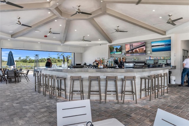 interior space with ceiling fan, beam ceiling, high vaulted ceiling, and indoor bar