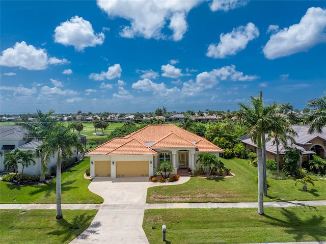 mediterranean / spanish home with a front lawn and a garage