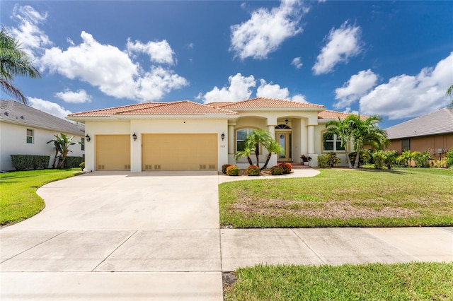 mediterranean / spanish-style house featuring a garage and a front yard