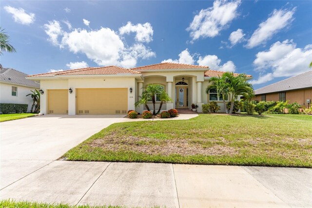 mediterranean / spanish-style home featuring a garage and a front lawn