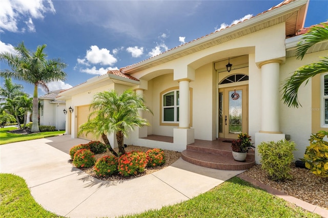 property entrance with covered porch and a garage