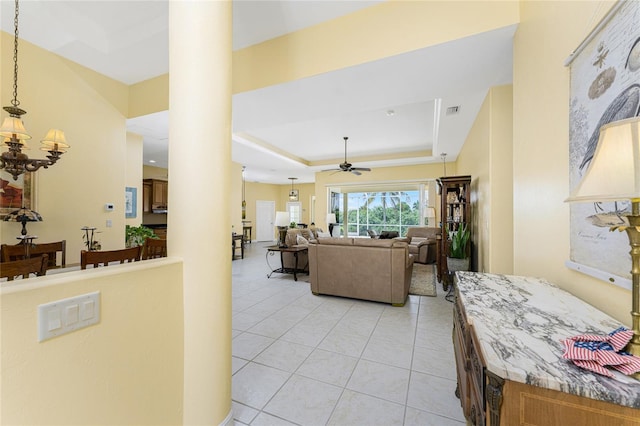 interior space with ceiling fan and a tray ceiling