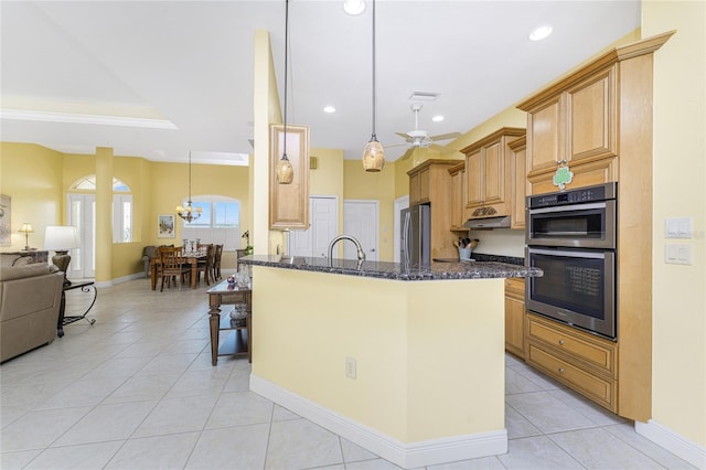 kitchen featuring pendant lighting, ceiling fan, appliances with stainless steel finishes, and dark stone counters