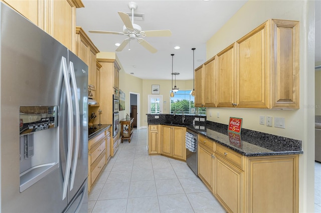 kitchen featuring pendant lighting, appliances with stainless steel finishes, ceiling fan, dark stone counters, and light tile patterned flooring