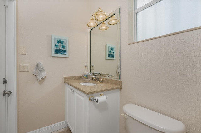 bathroom with toilet and vanity