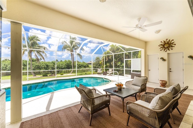 view of swimming pool with glass enclosure, ceiling fan, and a patio area