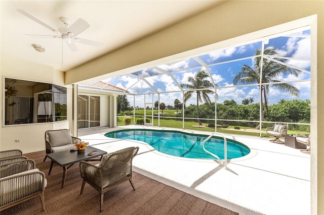 view of pool featuring a lanai, ceiling fan, and a patio area