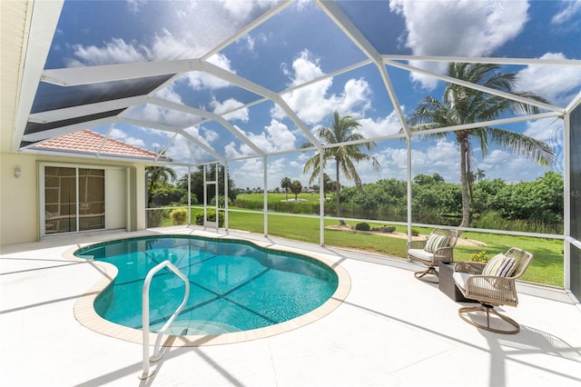 view of swimming pool with glass enclosure, a yard, and a patio