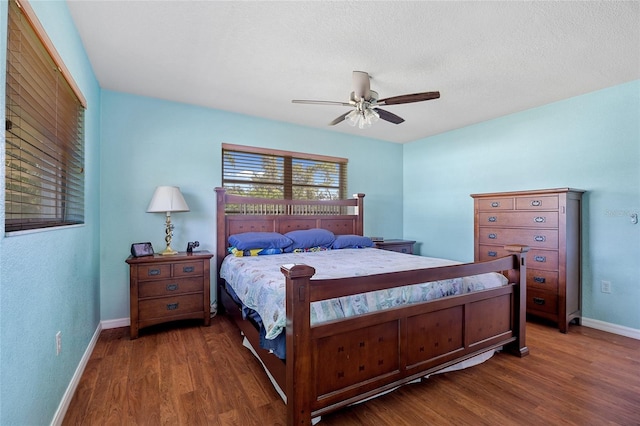 bedroom with a textured ceiling, dark wood-type flooring, ceiling fan, and a closet