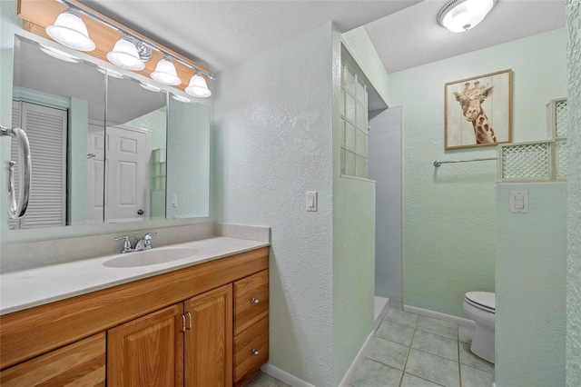 bathroom featuring a textured ceiling, vanity, walk in shower, tile patterned flooring, and toilet