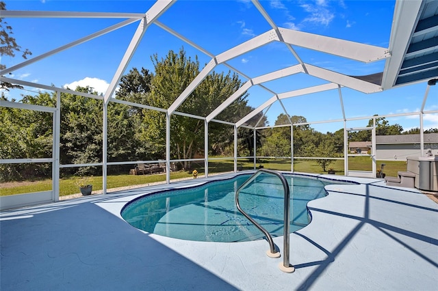 view of pool featuring a lanai, a patio area, and a lawn