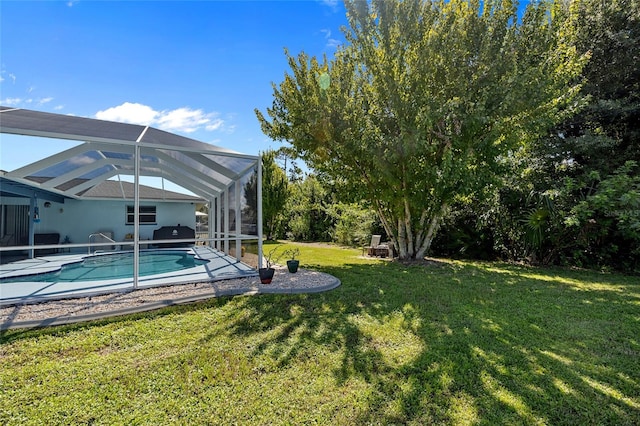 view of yard featuring a patio area and glass enclosure