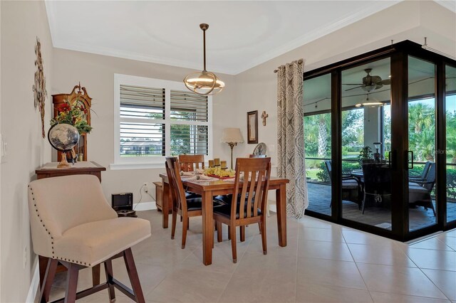 dining area with light tile patterned floors and crown molding