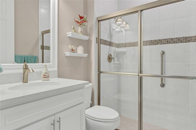 bathroom featuring vanity, toilet, and walk in shower