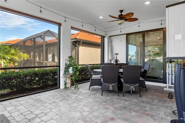 sunroom with a wealth of natural light and ceiling fan