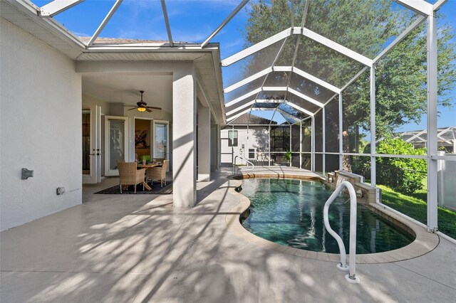 view of swimming pool featuring a patio area, ceiling fan, and a lanai