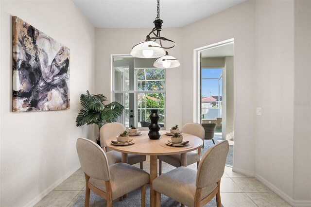 dining area featuring light tile patterned flooring