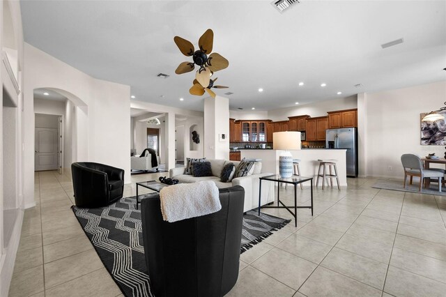 living room featuring ceiling fan and light tile patterned floors