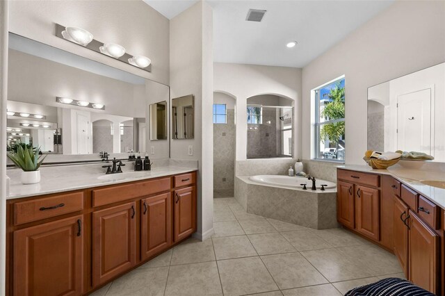 bathroom featuring vanity, plus walk in shower, and tile patterned floors