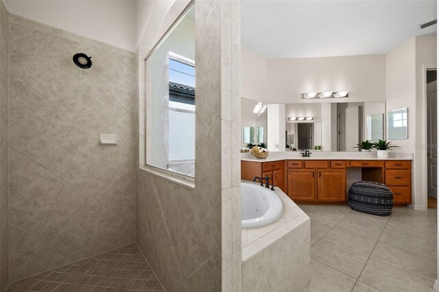 bathroom featuring a wealth of natural light, vanity, and shower with separate bathtub