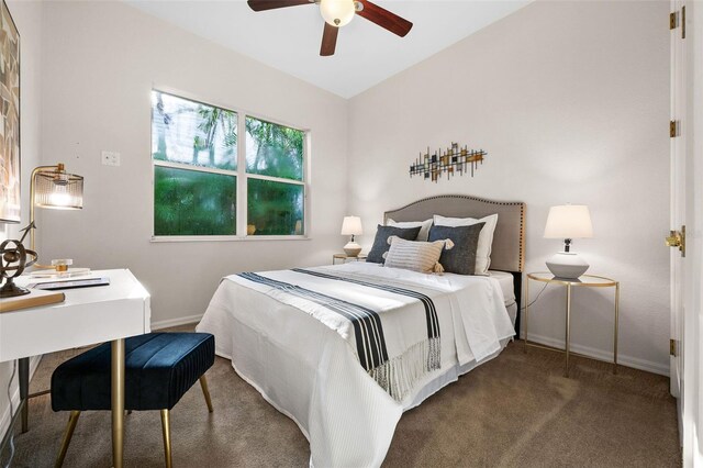 carpeted bedroom featuring lofted ceiling and ceiling fan