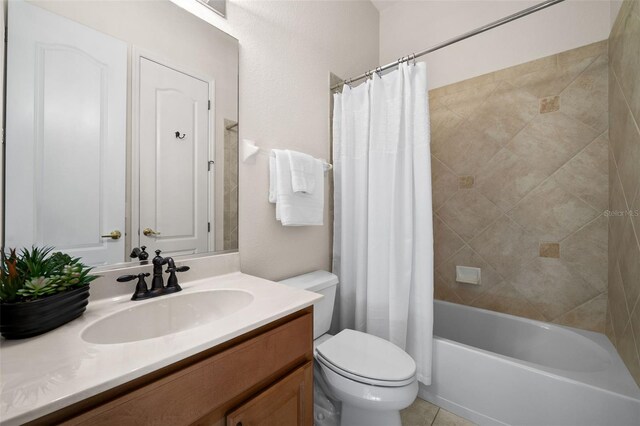 full bathroom with vanity, toilet, tile patterned floors, and shower / bath combo with shower curtain