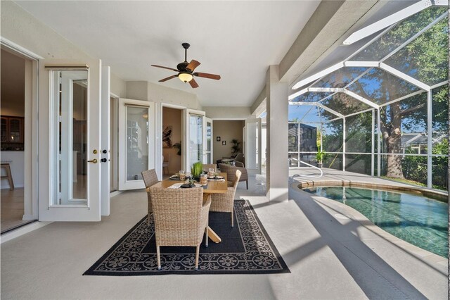 view of patio with ceiling fan and a lanai