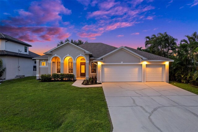 view of front of home featuring a garage and a yard