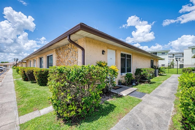 view of property exterior featuring a lawn