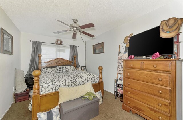 carpeted bedroom with ceiling fan and a textured ceiling