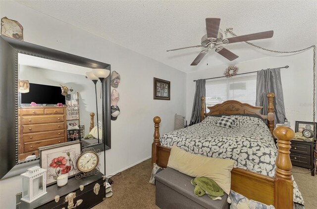 carpeted bedroom featuring ceiling fan and a textured ceiling