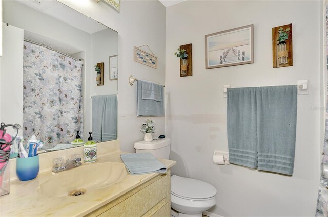 bathroom with toilet and vanity