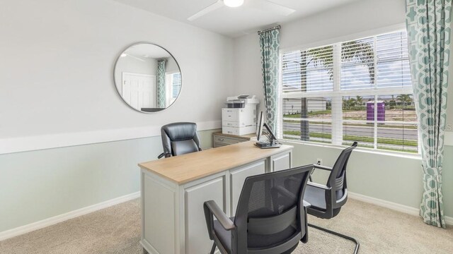 office space with ceiling fan and light carpet