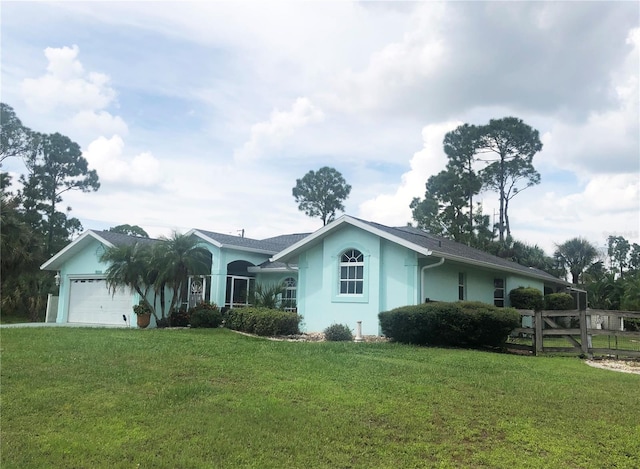 ranch-style home with a garage and a front yard