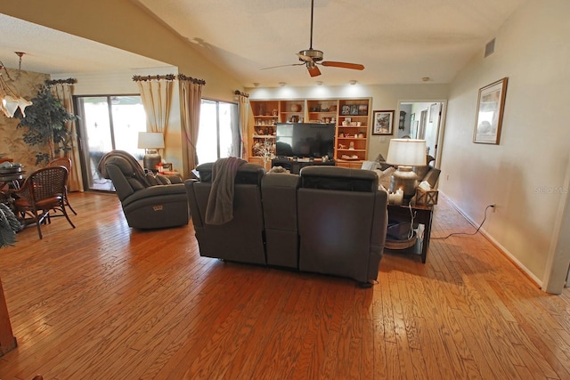 living room featuring lofted ceiling, ceiling fan, and hardwood / wood-style flooring